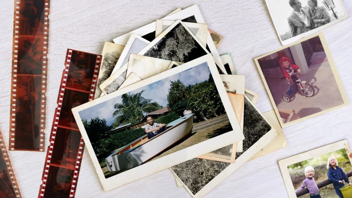 A grandparent looking fondly at an old family photo album